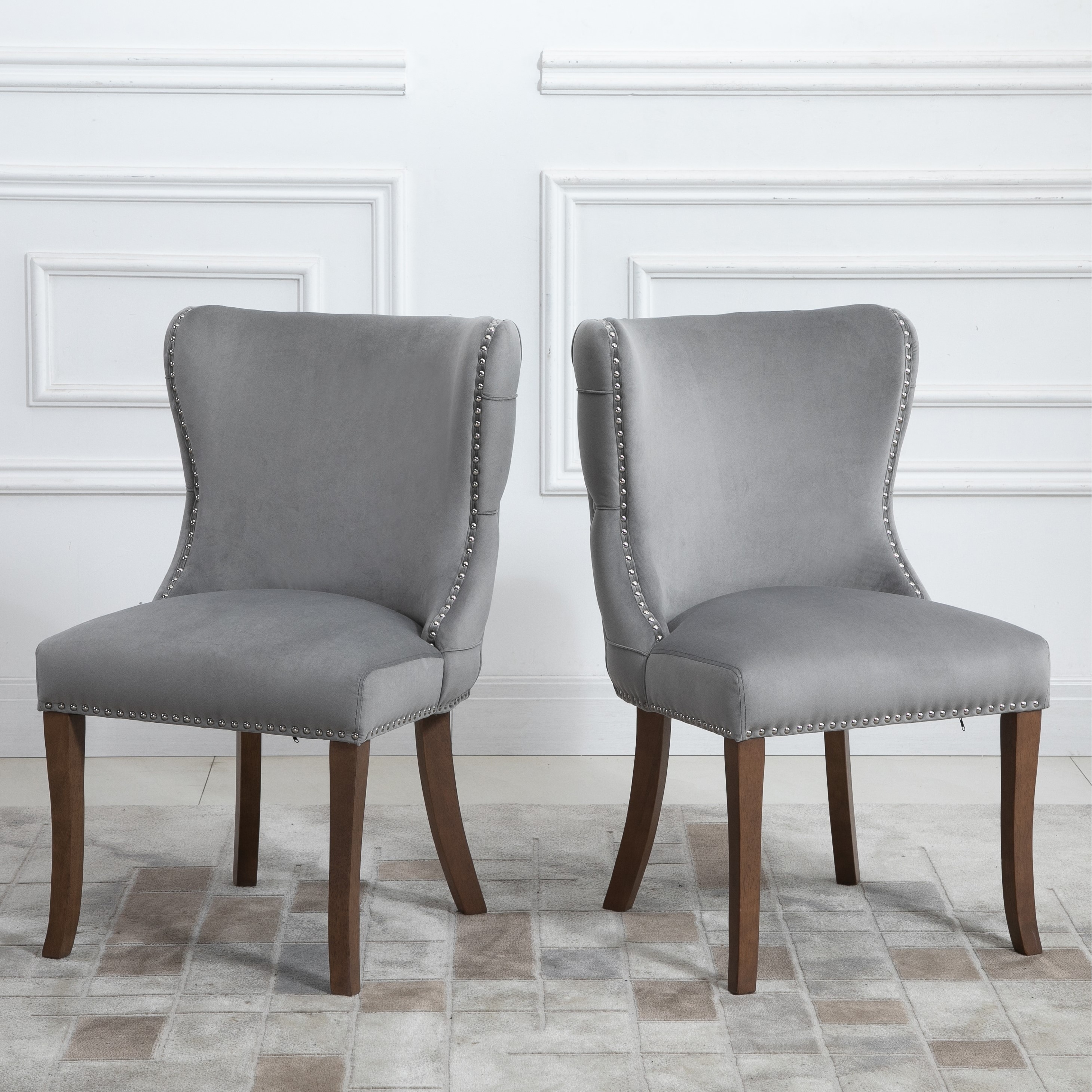 upholstered wing-back dining chair with backstitching nailhead trim